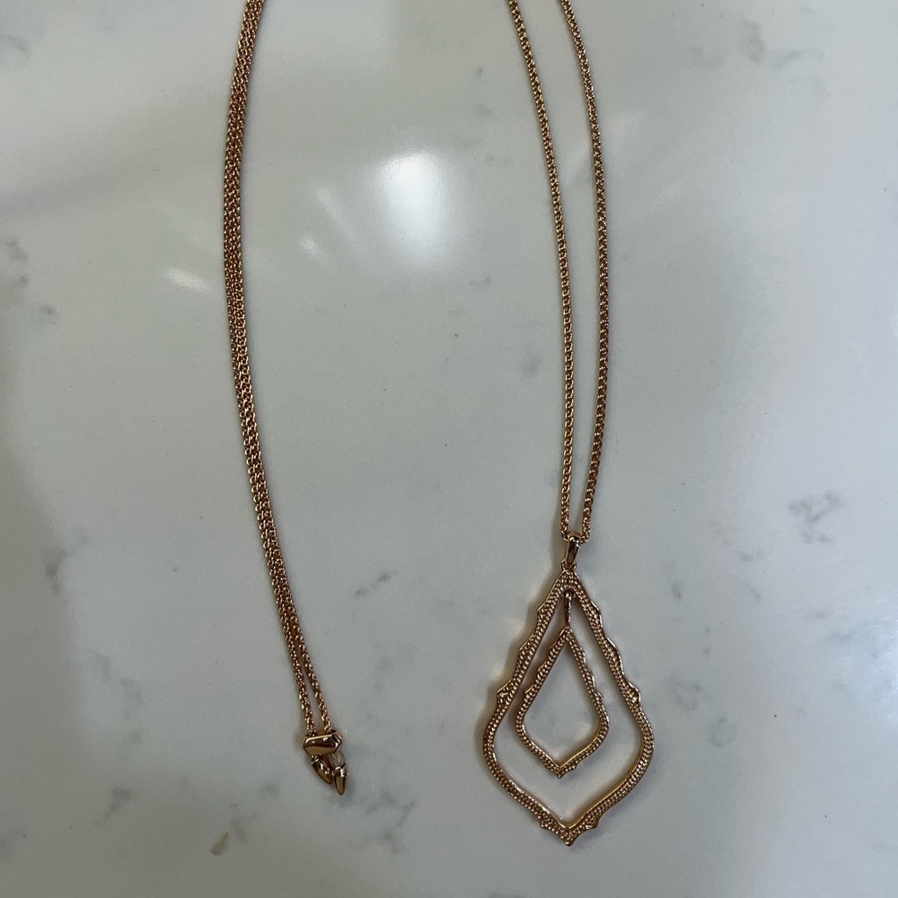 Kendra Scott rose gold long necklace.